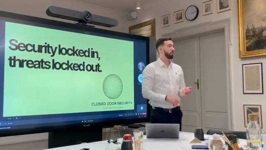 Cassius Edison presenting a Closed Door Security slide